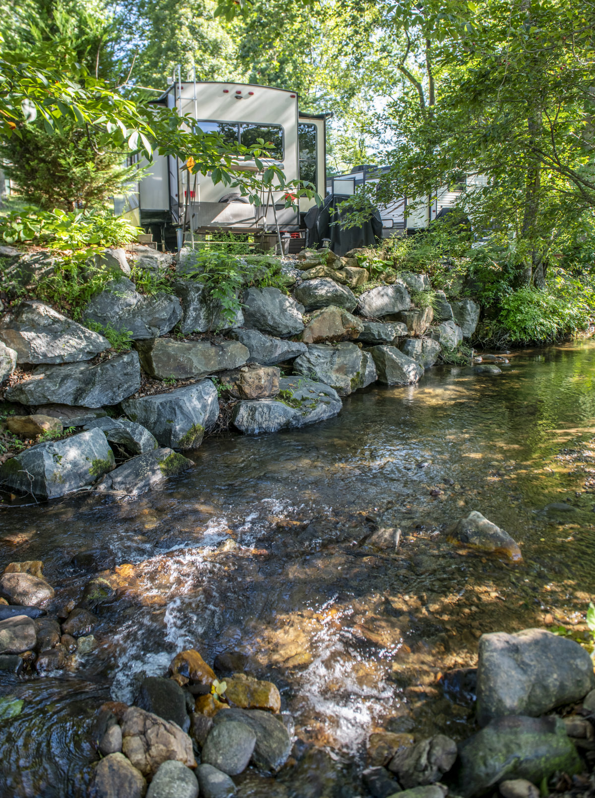 Camper beside a mountain stream at Hiawassee KOA Holiday