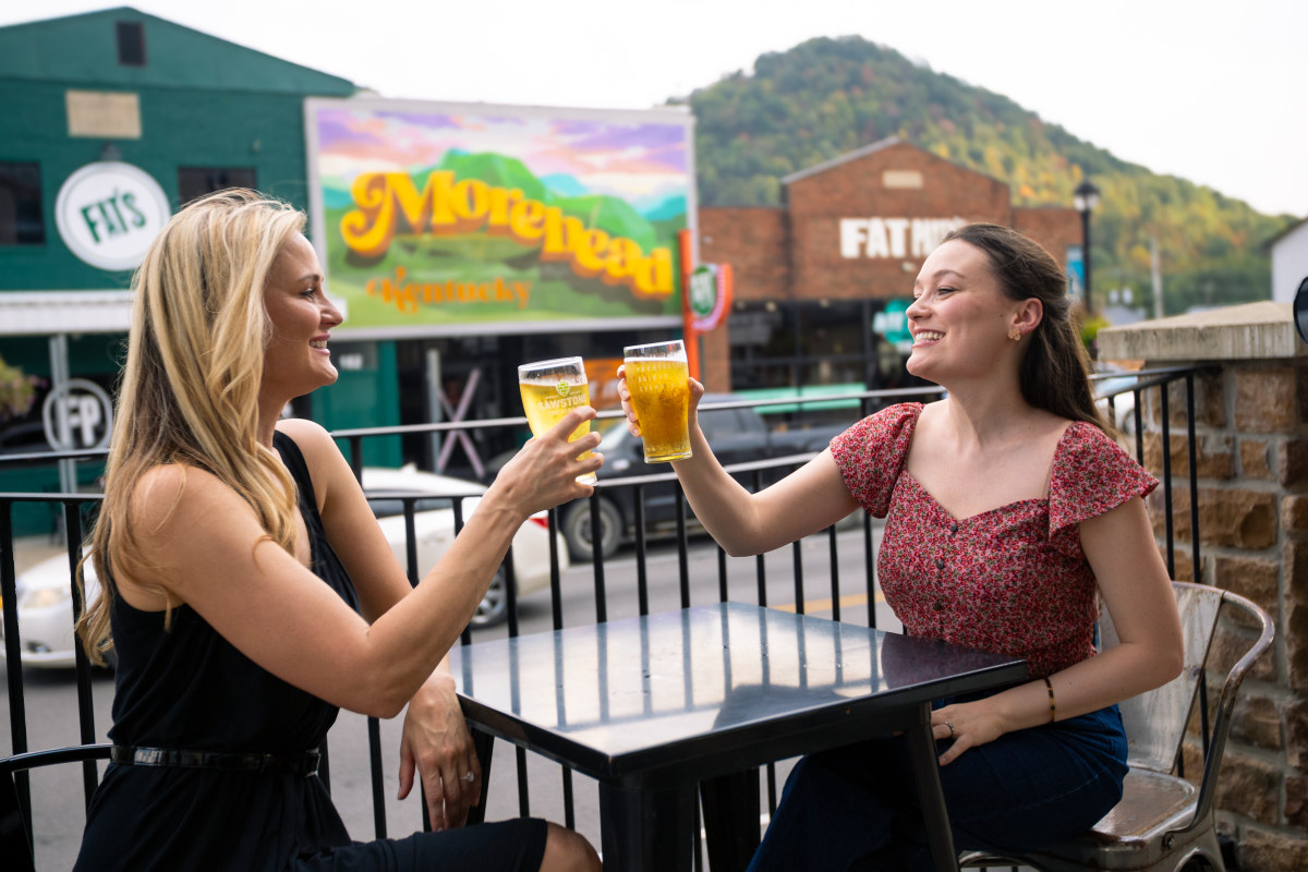 Visitors raising drinks in downtown Morehead, Kentucky