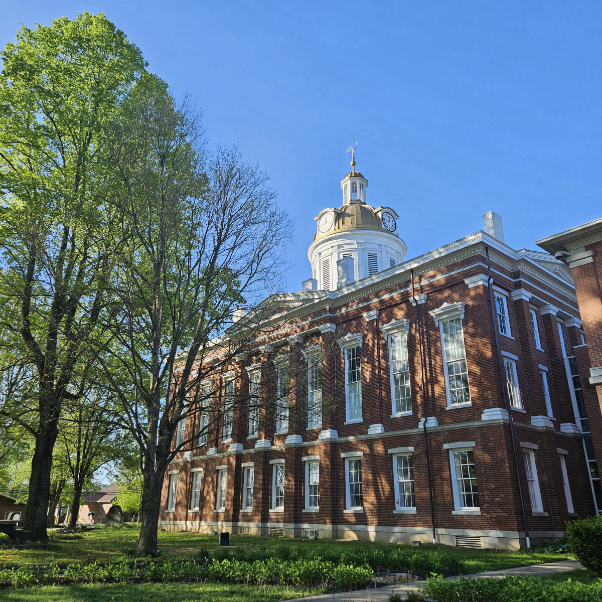 Historic courthouse beneath leafy trees in Switzerland County, Indiana